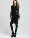 Statement leather sleeves lend chic edge to this Burberry Brit dress, flaunting a modest silhouette for a sleek and sophisticated look. For real downtown appeal, trade in your heels for chunky boots.