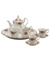 Garnished with the popular Old Country Roses dinnerware pattern, this bone china tea set from Royal Albert serveware brings the bounty of the English countryside to traditional afternoon tea. Scalloped rims and sculpted handles glisten in 22K gold.