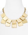 Tiered geometric shapes surround the neck with an Art Deco attitude on this modern Kenneth Jay Lane bib necklace, finished in gleaming 22 karat gold.