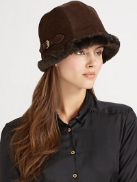 Sporty bucket shape with warm faux shearling trim is accented with golden buckle detail. Water-repellent One size fits most Italian calf suede Fully lined Dry clean by leather specialists Made in USA