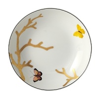 Embellished with butterflies flitting around golden branches, this porcelain coupe soup bowl from Bernardaud brings an elegantly fanciful look to your table.