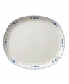 Vintage charm meets modern durability in the Farmhouse Touch serving plate, featuring cornflower-blue bands and blooms in premium porcelain from Villeroy & Boch.