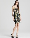 Imbued with a bold, painterly print, this Black Halo sheath cuts a curve-defining silhouette.