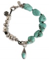 Totally charmed. Crafted from chic silver tone mixed metal and semi-precious turquoise stones, this bohemian-inspired bracelet from Lucky Brand lends a look that's elegant and easy going. Approximate length: 7-5/8 inches.