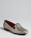 These SCHUTZ smoking flats add wow to a must-have silhouette with cracked metallic leather and spiked studs.