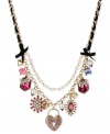 Betsey Johnson has the key to your heart. This frontal necklace flaunts heart lock charms with pink-colored crystal accents, fuchsia-colored crystal gems, glass pearls and faceted fuchsia bead. Finished with a black grosgrain ribbon, glass pearl chain and bubble hearts. Crafted in antiqued gold tone mixed metal. Approximate length: 16 inches + 3-inch extender. Approximate drop: 2-1/4 inches.