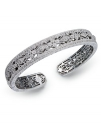 Deck yourself out in diamonds. This exquisite bangle features a cut-out floral pattern decorated with round-cut diamonds (1/2 ct. t.w.). Set in sterling silver. Approximate diameter 2-1/2 inches.