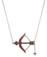 Aiming to please, this necklace from Betsey Johnson is crafted from antique gold-tone mixed metal with a pendant adorned with sparkling fuchsia accents. Item comes packaged in a signature Betsey Johnson Gift Box. Approximate length: 16 inches + 3-inch extender. Approximate drop: 1-3/4 inches.