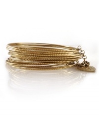 Layer on the luxury with a chic bangle set by Jessica Simpson. Set features 24 textured bangles in worn gold tone mixed metal. Bangles held together by a small chain with heart logo. Approximate diameter: 2-1/2 inches.