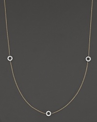 A delicate yellow gold chain with three double-sided white gold diamond circle stations.