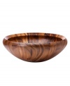 A natural choice for entertaining, this staved wooden salad bowl from Dansk's collection of serveware and serving dishes boasts timeless style in a rich, striking grain. With a curved rim to prevent spills.