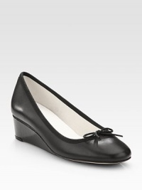 An elevated self-covered wedge silhouette of patent leather, topped with a pretty grosgrain bow. Self-covered wedge, 1½ (40mm)Leather and grosgrain upperLeather liningRubber solePadded insoleMade in France