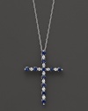 Diamonds and sapphires in a 14K white gold cross pendant on a fine chain.