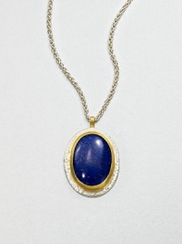 A beautiful, speckled lapis cabochon set in sterling silver and 24k gold on a link chain. LapisSterling silver24k goldLength, about 17.7Pendant size, about 1.2Lobster clasp closureImported 