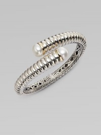 From the Bedeg Collection. A richly ribbed hinged cuff of gleaming sterling silver with accents of 18k gold has overlapping endcaps set with lustrous pearls.White pearlsSterling silver and 18k yellow goldDiameter, about 2¼Width, about ½HingedImported