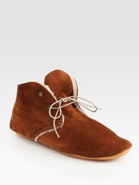 Cozy shearling lines this ultra-comfortable suede design with a rubber sole for added traction. Suede upperShearling liningRubber solePadded insoleMade in Italy