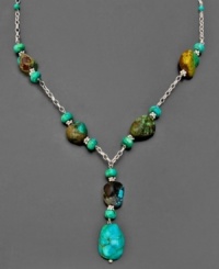 Accent any outfit with the radiant hue of turquoise. This earthy necklace combines sterling silver and rustic turquoise stones in with natural splendor. Measures approximately 18 inches long. Approximate drop: 2 inches.