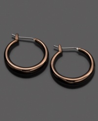 Fossil spices up traditional hoops with a chic ionic brown plating. Earrings crafted in mixed metal. Approximate diameter: 3/4 inches.