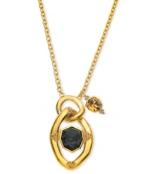 Center of attention. T Tahari's necklace features a black crystal secured in a pendant, with an amber-hued accent. Crafted from nickel-free 14k gold-plated mixed metal. Approximate length: 32 inches. Approximate drop: 2-7/8 inches.