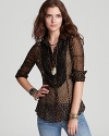 A gold metallic floral print enlivens this sheer Free People shirt with on-trend flair this fall--dress up your denim.