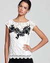 A stunning lace appliqué stands out on this Nanette Lepore top, for a look that's full of ladylike charm.