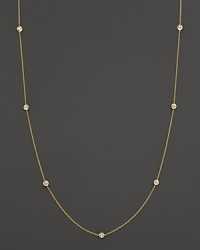 Diamond stations punctuate a long, elegant 18K yellow gold chain. By Roberto Coin.