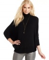 Kick back in this poncho-style top from Calvin Klein Jeans. It's the perfect silhouette with the season's skinny jeans.