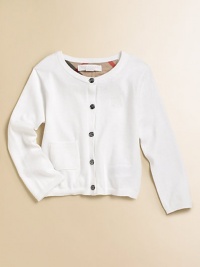 A classic sweater with Burberry touches, perfect atop her pretty dresses, skirts or even her jeans.Ribbed crew necklineButton frontEmbroidered tonal chest logoRibbed patch pocketLong sleeves with ribbed cuffsRibbed hemCottonHand washImported Please note: Number of buttons may vary depending on size ordered. 