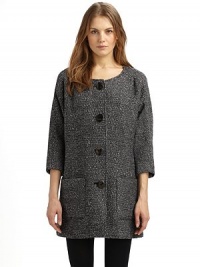 A simple collarless shape in a luxurious wool blend, with dolman sleeves and rustic wooden buttons.Round neckline Seamed yoke, front and back ¾ kimono sleeves Button front Dual patch pockets at front Fully lined About 33 from shoulder to hem 78% wool/18% polyester/4% other fibers Dry clean Made in USA