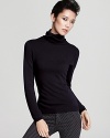 The ideal contrast to of-the-moment printed pants and colored denim, this C by Bloomingdale's turtleneck flaunts a classic silhouette in sumptuous cashmere for instant chic.