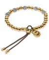 Add a little heat to your look. Michael Kors' stretchable bracelet combines gold tone beads with pave crystal fireballs. Crafted in gold tone mixed metal with an adjustable leather cord. Approximate diameter: 2-1/4 inches. Approximate width: 1/8 inch.