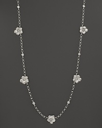 Delicate gardenias, captured at the height of their beauty in sterling silver, bloom on this necklace from Buccellati.