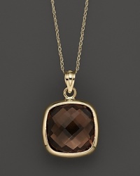 A bold, faceted smoky quartz glitters in a 14K yellow gold setting.