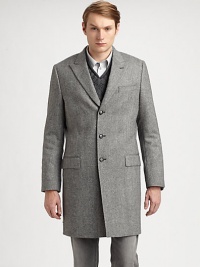 Tailored in virgin wool, this tweed overcoat is the ultimate winter wardrobe option for the dapper, gentleman of style.Button-frontChest welt, hip flap pocketsAbout 37 from shoulder to hemVirgin woolDry cleanMade in Italy