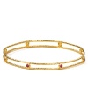 Embrace the season's eclectic approach to accessorizing with this delicate layered gold-plated bangle from Melinda Maria, adorned with striking ruby red-colored stones.