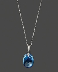 Diamonds accent a checkerboard blue topaz, set in 14K white gold.