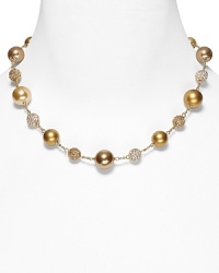 Carolee's necklace with alternating plain and pave beads lends a chic, sparkling finish to your look.