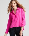 Pretty in pink, this airy Amanda Uprichard shirt of rich silk takes on the high/low trend and masters it.