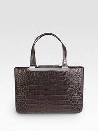 Luxurious crocodile embossed leather in a classic, structured shape with sleek hardware.Double top handles, 7½ dropMagnetic snap strap closureProtective metal feetThree inner compartmentsTwo inside zip pocketsFour inside open pocketsFully lined13½W X 9H X 4½DImported