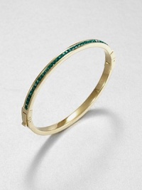 From the Cocktail Collection. Meticulously faceted, emerald-colored stones line one side of this slender bangle, in deep contrast to the other side of polished goldtone.GlassGoldtoneDiameter, about 2.5Hinged with push-lock claspImported