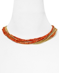 Let MICHAEL Michael Kors lend every look a colorful touch with this beaded coral and gold tone bib necklace. It's bold layered look instantly enlivens your neckline.