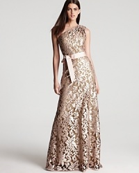 Sequin encrusted lace makes a dazzling appearance on Tadashi Shoji's sophisticated one shoulder dress.