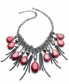 Take a walk on the wild side. Style&co.'s fierce statement necklace bites back with plastic beads with snakeskin vinyl and smoky metal fringe. Crafted in hematite tone mixed metal. Approximate length: 18 inches + 2-inch extender. Approximate drop: 7 inches.