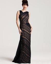 Elegant contrast pleating makes a stunning style statement in this asymmetric evening gown from Tadashi Shoji. This inimitable look promises all eyes will be on you.