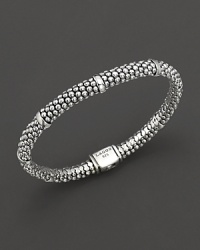 Sterling silver Caviar™ beaded oval rope bracelet with five smooth stations. Logo box clasp closure. Designed by Lagos.