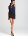 A short silhouette takes on a color blocked look, detailed with a front keyhole and draped front. From Black Halo.