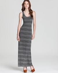 Accentuating your curves while camouflaging your problem areas, the optical illusion of variegated stripes crafts a slimming Three Dot maxi dress. Punctuate the tonal silhouette with acid-bright accents for an on-trend pop of color.