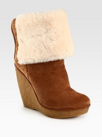 Plush shearling luxes up this suede versatile design that can be folded down, atop a rubber wedge and platform. Rubber wedge, 4¾ (120mm)Rubber platform, 1 (25mm)Compares to a 3¾ heel (95mm)Unfolded: shaft, 10Unfolded: leg circumference, 13Suede upperBack zip and secured by snaps when foldedShearling liningRubber solePadded insoleImported