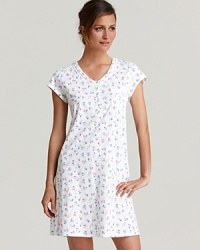 A soft short sleeve nightshirt in a floral print with pleated V-neckline and a lace trimmed chest pocket.