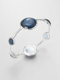 From the Wonderland Collection. Round faceted indigo doublet stations in various sizes set on a hammered sterling silver bangle. Indigo doubletSterling silverDiameter, about 2.5Slip-on styleImported 